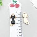 Detail of black enamel cat pendant showing dimensions with a ruler for DIY jewelry crafts - Black Back View Cat (9928) / 1 Piece (11x22mm) / Black