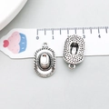Macro view of vintage silver cowboy hat pendants with intricate rope texture and link ring - Cowboy Hat Shape (14035)
