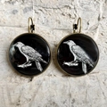 Macro detail of gothic raven skull earrings with bronze lever-back frames on stone - Crow Sketch Pattern (2) / Bronze