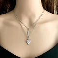 Detail of layered silver necklaces featuring feather and cactus charms on a model - Feather And Cactus Style (2)