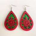 Close-up of teardrop Christmas earrings with red felt snowflake and green glitter layer - Red Green Snowflake