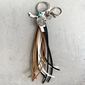 Porte-clés style western en cuir tête de vache avec turquoise et longs pompons en daim - Imprimé Vache (1)