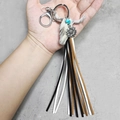 Detail of leather tassel keychain with western bull head charm and turquoise bead decor - Fuzzy Cow Head Style (4)