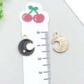 Black enamel crescent moon pendant with stars on a golden metal base and ruler reference - Black Moon (11904)