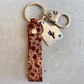 Handmade leather keychain with gold splatter texture, silver cactus tag and turquoise bead - Reddish Brown Cactus Style (4937061546909)