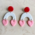 Macro detail of handmade heart arch clay earrings with red studs and pink pendants - Heart Arch Style