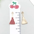 Golden and red enamel broom-shaped charms with sunburst texture on a measuring scale - Halloween Broom (14016)