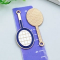 Close-up of enamel tennis racket charms showing both sides with blue and white finish - White Enamel Racket