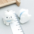Macro view of 2cm mini flocked white dog pendants with blue collars and metal rings - White Resin Flocked Friendly Puppy (24801)
