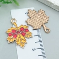 Detail of yellow maple leaf enamel pendant with red bow and gold textured back on scale - Yellow Enamel Thanksgiving Bow Maple Leaf (25230)