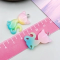 Close-up of glitter gradient resin cat pendants being measured with a pink ruler - Pink Green Glitter Gradient Cat (24308)