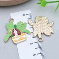 Detailed macro view of enamel puppy flowerpot pendant with 3cm measurement and back texture - Springer Spaniel Potted Plant Style