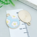 Light blue flower enamel Easter egg pendant with gold sunburst pattern back - Cyan Flower Egg (25123)