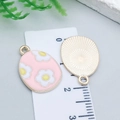 Pink enamel Easter egg pendant with yellow flower and gold metal back for DIY jewelry - Pink Flower Egg (25124)