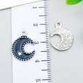 Navy blue moon alloy charm with star detail and textured back shown by a ruler - Stars & Moon (23970) / 1 Piece Pack (17x12x1mm) / Black