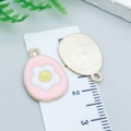 Pink enamel Easter egg charm with white flower and yellow smiley face for DIY jewelry - Pink Frangipani Egg (25127)
