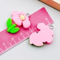 Pink resin tulip pendant with green leaves and metal loop next to a ruler for size scale - Rose Red Pointed Five-Petal Flower (24348) / 29*23*7mm