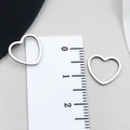 Pair of hollow heart stainless steel pendants in silver finish with size ruler reference - Heart Style