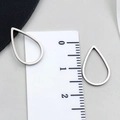Silver steel teardrop hollow pendant charm for DIY jewelry making displayed with scale - Water Drop Style