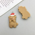 Detailed view of a cute resin Christmas bear pendant with a festive red hat for DIY crafts - Brown Christmas Bear