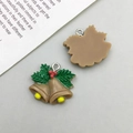 Detail view showing front and back of Christmas holly berry bells with metal hanging rings - Brown Christmas Bell