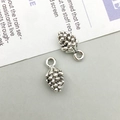Close-up of realistic silver pine cone pendants with textured scales for DIY jewelry - Antique Silver Small Pine Cone (4014)