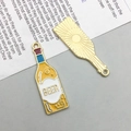 Detailed view of beer bottle alloy charms showing yellow enamel front and golden sunburst back - Enamel KC Gold Beer Bottle (16740)