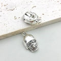 Detailed macro view of two silver skull charms showing front and back hollow design - Skull 11x20mm (3341)