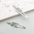 Detailed macro of vintage silver skull pendant with realistic skeletal texture and top loop - Antique Silver Skeleton 9x39mm (15762)
