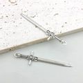 Detailed macro view of vintage silver sword pendants with intricate embossed patterns - Antique Silver Sword 12*49mm (16192)