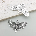 Close-up of vintage moth charms with skull detail and hollow wing patterns - Antique Silver Skull Moth Butterfly 43x27mm (16928)