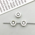 Macro detail of three retro flower-shaped silver alloy spacer beads for DIY jewelry making - Antique Silver Flower Spacer Bead (16328)