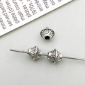 Macro detail of vintage silver alloy spacer beads with ethnic embossed floral patterns - Antique Silver Round Spacer Bead (16331)