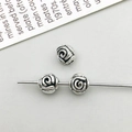 Macro shot of antique silver alloy beads with detailed rose pattern for DIY jewelry - Antique Silver Rose Spacer Bead (16332)