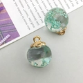 Close-up of glass orb pendant filled with light blue dried flowers and golden cap - Lake Blue Gypsophila Glass Ball (16407) / 1 Piece (16x20mm) / Lake Blue