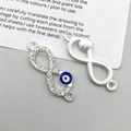 Detail of silver infinity evil eye charms with blue enamel and sparkling crystals - Infinity Symbol (14550) / 27*10mm