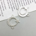 Macro detail of silver moon and star connectors with white rhinestones for DIY jewelry - Moon and Stars Style (14600) / 18x20mm