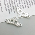 Makroaufnahme von silbernen Kronen-Anhängern mit funkelnden Strasssteinen für DIY-Schmuck - 22x11mm