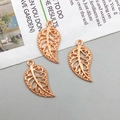 Detailed view of three rose gold hollow leaf charms with intricate filigree texture - Rose Gold (10095)