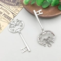 Detailweergave van twee vintage zilveren sleutelhangers met barokke opengewerkte patronen - Sleutel 30*70mm - 3579