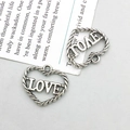 Detail of vintage silver heart pendants with LOVE cutout and twisted rope texture design - Antique Silver Heart Love (10902)