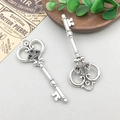 Detail of vintage silver alloy key charms with crown and vine motifs on a rustic tray - Key 33*85mm - 4175