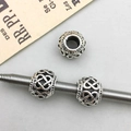 Macro detail of antique silver Celtic knot hollow beads for DIY jewelry making - Antique Silver Hollow Flower Style (16634) / 1 Piece/Pack (9x11mm)