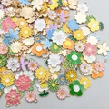 Flat lay of colorful enamel flower charms with gold bases for DIY jewelry making - Random Mixed Enamel Flowers (SN488)
