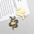 Detail of snake enamel pendant showing black sun pattern and golden textured back - Black Enamel Sun Snake (18171)