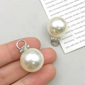 Close-up of white pearl pendant with silver metal and small diamonds detail - White K ABS Pearl Rhinestone Loop 16mm