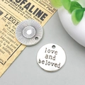 Macro view of vintage silver round alloy charms with engraved love text and sunburst patterns - Love And Beloved Style (2490)