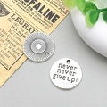 Detailed view of round antique silver charms with never give up engraving for DIY jewelry - Never Give Up Style (2492)