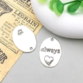 Detailed macro view of an oval silver alloy pendant featuring engraved always text and heart - Always Letter Style (7018)