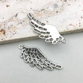 Detail of silver wing pendants showing feather textures and hollow back for DIY jewelry - Hollow Feather Wing Style (10050)